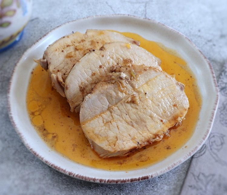 Slices of pork loin with beer sauce on a plate