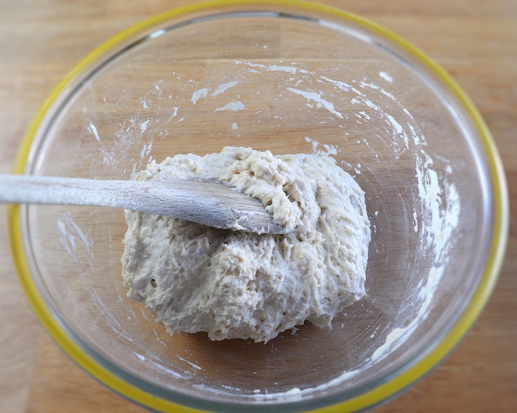 Pizza dough on a large glass bowl