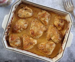 Baked chicken with lemon and garlic sauce on a baking dish