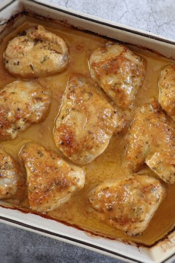 Baked chicken with lemon and garlic sauce on a baking dish