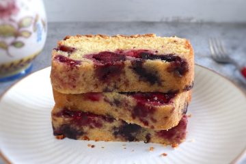 Easy triple berry cake slices on a plate