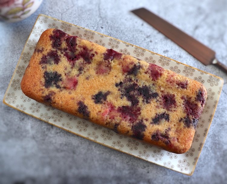 Easy triple berry cake on a rectangular platter