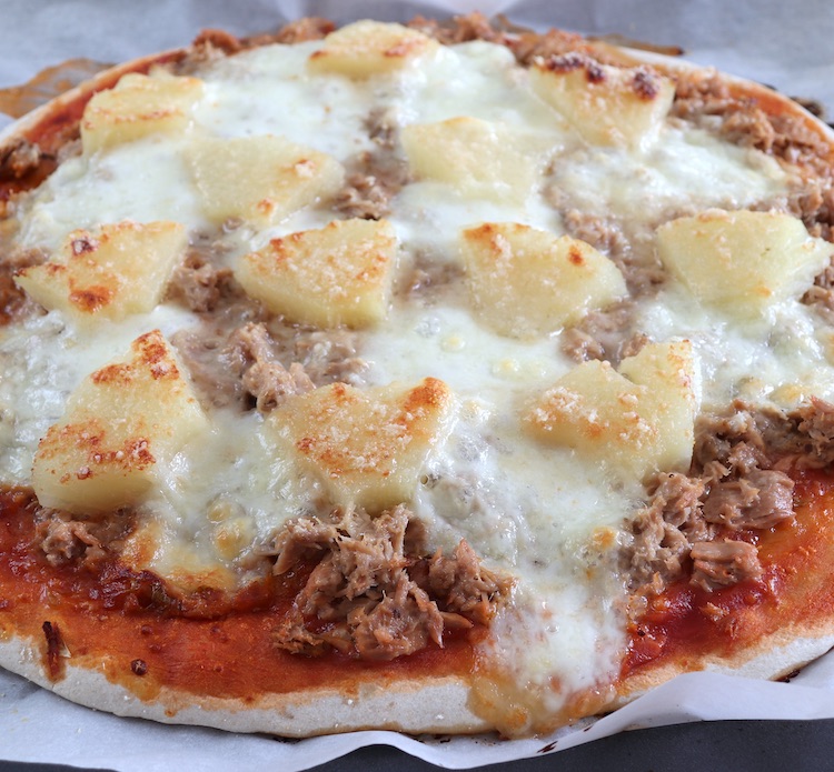 Homemade cheese pizza with tuna and pineapple Recipe on a baking tray