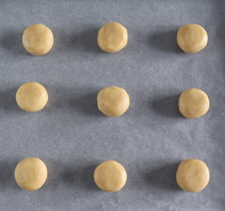 Cookies dough on a tray with parchment paper
