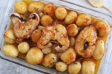 Baked fish with lemon and thyme on a glass baking dish