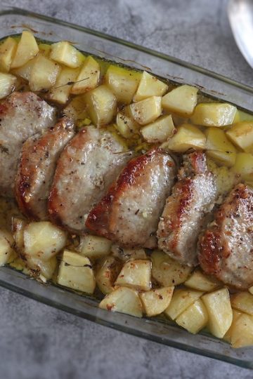 Easy roasted pork loin with potatoes on a baking dish