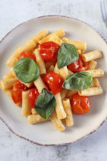 Easy Parmesan pasta with cherry tomato on a plate