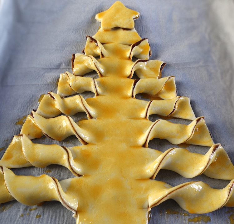 Sapin de Noël badigeonné de jaune d'oeuf sur une plaque à pâtisserie