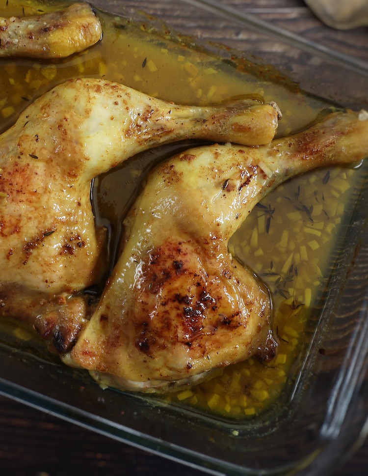 Oven Baked Chicken Leg Quarters on a glass baking dish