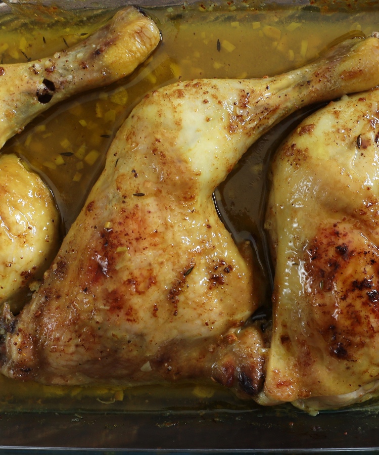 Oven Baked Chicken Leg Quarters on a glass baking dish
