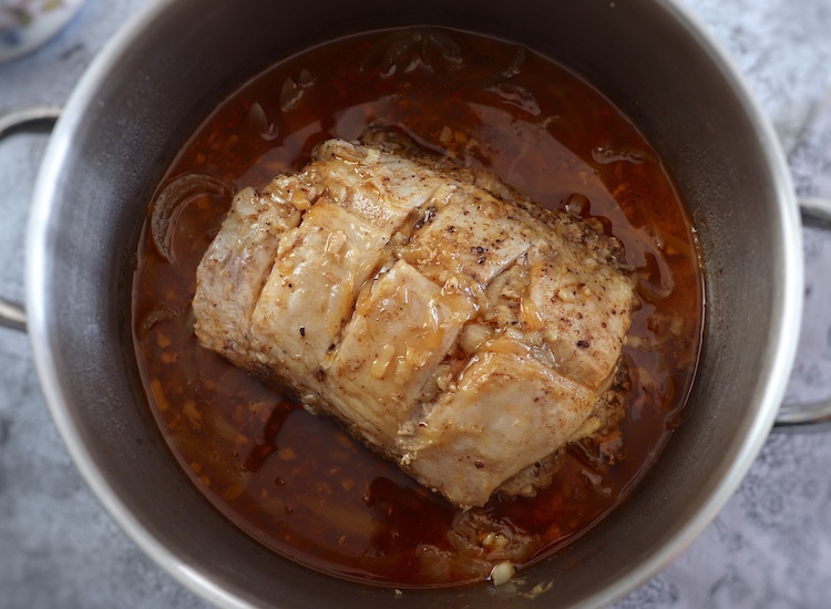Pork loin with beer sauce in a large saucepan