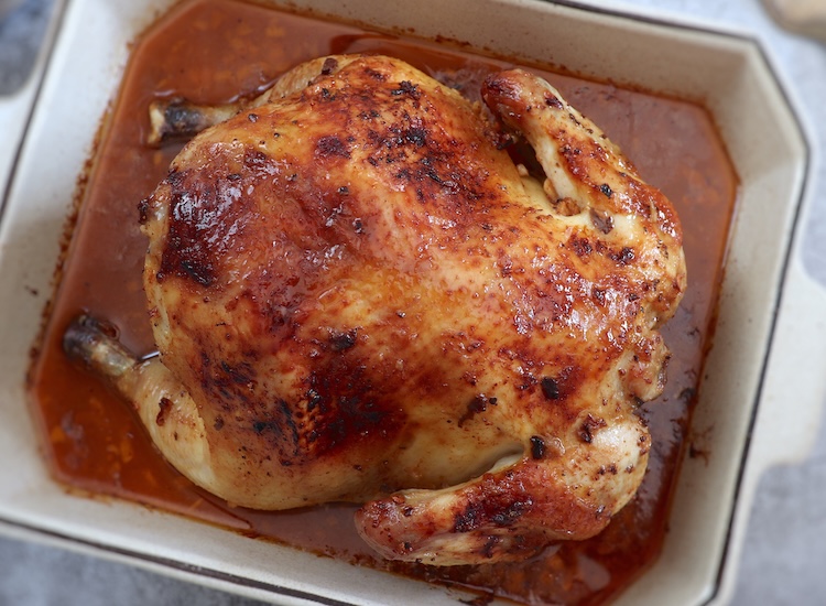 Honey lemon roast chicken in a baking dish